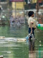 Patna: A rag picker collects plastic drinking bottles floating on floodwaters after water levels receded at Rajendra Nagar area, in Patna, Sunday, Oct. 06, 2019. (PTI Photo)(PTI10_6_2019_000086B)