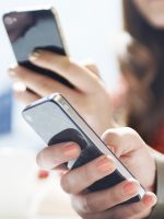 hands texting with mobile phones in cafe