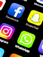 Sankt-Petersburg, Russia, July 29, 2018: Apple iPhone X with icons of social media facebook, instagram, twitter, snapchat, google application on screen. Social media icons. Social network