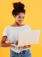 young-positive-cool-lady-with-curly-hair-using-laptop-isolated_171337-6666